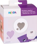 Verpackung für einen Flexi-Stanzer mit Herzmotiv. Farben: Weiß und lila. Auf der Vorderseite sind ausgestanzte Herzen abgebildet.