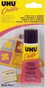Kleber für Stoff, Filz und Bänder. Verpackung in Gelb und Schwarz. Tube mit 38 ml Inhalt. Mehrsprachige Hinweise auf der Rückseite.