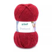 Rotes Wollknäuel mit der Aufschrift 'Shetland'. Verpackt mit einem Etikett von der Marke grünDl.