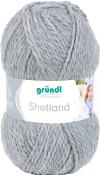 Grauem Wollknäuel mit der Bezeichnung Shetland. Verpackung zeigt eine Frau mit einem Schal.