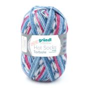 Wollknäuel in Blau, Rosa und Weiß. Eignet sich für Socken. Superwash, 6-fach. Etikett mit Produktinformation.