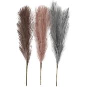 Drei dekorative Pampasgras-Stäbe in verschiedenen Farben. Von links nach rechts: Braun, Rosa, Grau.
