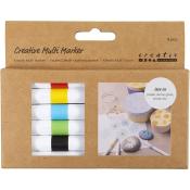 Set von sechs kreativen Markern in verschiedenen Farben. Verpackung zeigt Anwendung auf verschiedenen Oberflächen.