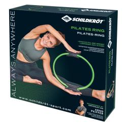 Ein grüner Pilates-Ring mit schwarzen Griffen. Der Ring hat eine runde Form.