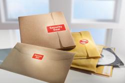 Gelbe Verpackung mit Aufklebern für Sicherheitsanwendungen. Roter Schriftzug 'Security Seal' auf der Vorderseite.