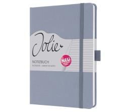 Graues Notizbuch mit elastischem Verschluss. Auf dem Cover steht 'Jolie Notizbuch' und ein rotes 'NEU'-Schild.