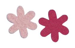 Zwei blumenförmige Aufkleber. Eine in zartem Rosa, die andere in kräftigem Rot.