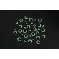 Eine Ansammlung von Wackelaugen in verschiedenen Größen. Runde, transparente Kunststoffoberfläche mit schwarzem Punkt in der Mitte.