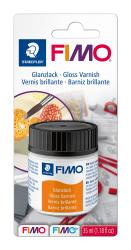 Behälter mit Glanzlack für Bastelarbeiten. Verpackung zeigt Pinsel und bunte Objekte.