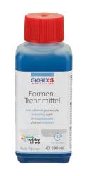 Flasche mit blauem Inhalt und rotem Deckel. Beschriftung mit Informationen zu einem Trennmittel für Formen.
