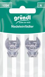 Verpackung mit zwei Nadeleinfädeln. Metallisch, mit einem Profil eines Mannes. Grüner Hintergrund mit weißem Text.