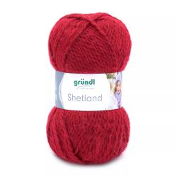Rotes Wollknäuel mit der Aufschrift 'Shetland'. Verpackt mit einem Etikett von der Marke grünDl.