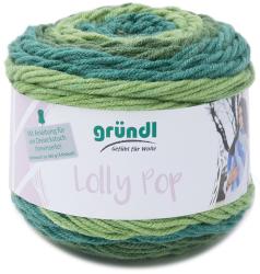 Wollknäuel in Grüntönen. Verpackung mit der Aufschrift 'Lolly Pop' und Anleitung für ein Dreieckstuch.