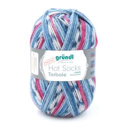 Wollknäuel in Blau, Rosa und Weiß. Eignet sich für Socken. Superwash, 6-fach. Etikett mit Produktinformation.