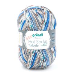 Wollknäuel in verschiedenen Farben, hauptsächlich Blau, Braun und Beige. Geeignet für Socken, 6-fach Superwash.