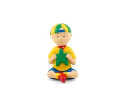 Figur eines Jungen mit gelbem T-Shirt und blauer Shorts. Hält einen grünen Stern in der Hand. Im Hintergrund ein Buchcover mit dem Titel 'Caillou: Sternschnuppen und weitere Geschichten'.