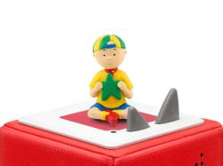 Figur eines Jungen mit gelbem T-Shirt und blauer Shorts. Hält einen grünen Stern in der Hand. Im Hintergrund ein Buchcover mit dem Titel 'Caillou: Sternschnuppen und weitere Geschichten'.