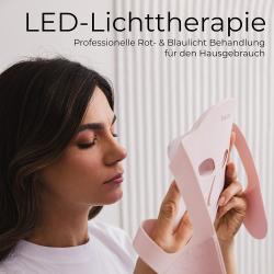 rosa Gesichtsmaske mit Augen- und Nasenausschnitten. Muster aus sich überlappenden Rauten. Elastische Bänder an den Seiten.