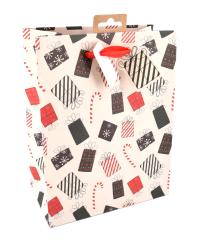 Geschenktüte mit buntem Geschenkedesign. Farben sind rot, schwarz und weiß.