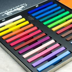 Packung mit 24 harten Pastellkreiden. Bunte Kreiden liegen auf einem farbigen Hintergrund.
