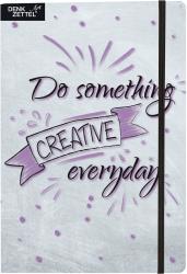 Notizbuch mit grauem Cover. Auf dem Cover steht 'Do something CREATIVE everyday' in lila Schrift.