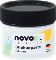 Ein runder Behälter mit schwarzem Deckel. Beschriftung mit 'Strukturpaste Feinsand' und bunten Elementen.