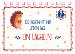 Weihnachtliche Karte mit Igel, der ein Geschenk hält. Bunte Schneeflocken und Herzen, rote und blaue Akzente, Text: Du schenkst mir jeden Tag ein Lächeln.
