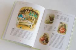 Buchcover von Beatrix Potter mit dem Titel 'Peter Hase'. Illustration eines Hasen im Garten mit einer Schaufel.