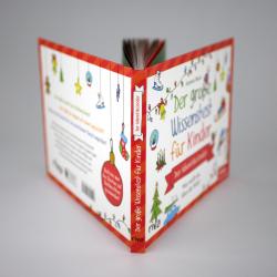 Offenes Buch mit bunten Weihnachtsmotiven und Text. Der Titel lautet Der große Wissensspaß für Kinder.