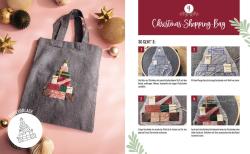 Graue Stofftasche mit Henkel. Auf der Vorderseite ein Stickmuster eines Weihnachtsbaums aus bunten Geschenkpaketen.