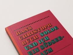 Buchcover mit dem Titel 'Hans Christoph Buch Nolde und ich ein Suedsee-Traum'. Farbige Schrift auf einem rosa Hintergrund.