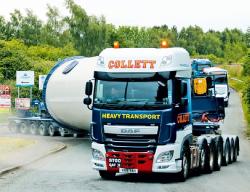 Cover des Jahrbuchs 2021 über Schwertransporte und Autokrane. Abgebildet ist ein großer Transport mit einem zylindrischen Objekt auf der Straße.