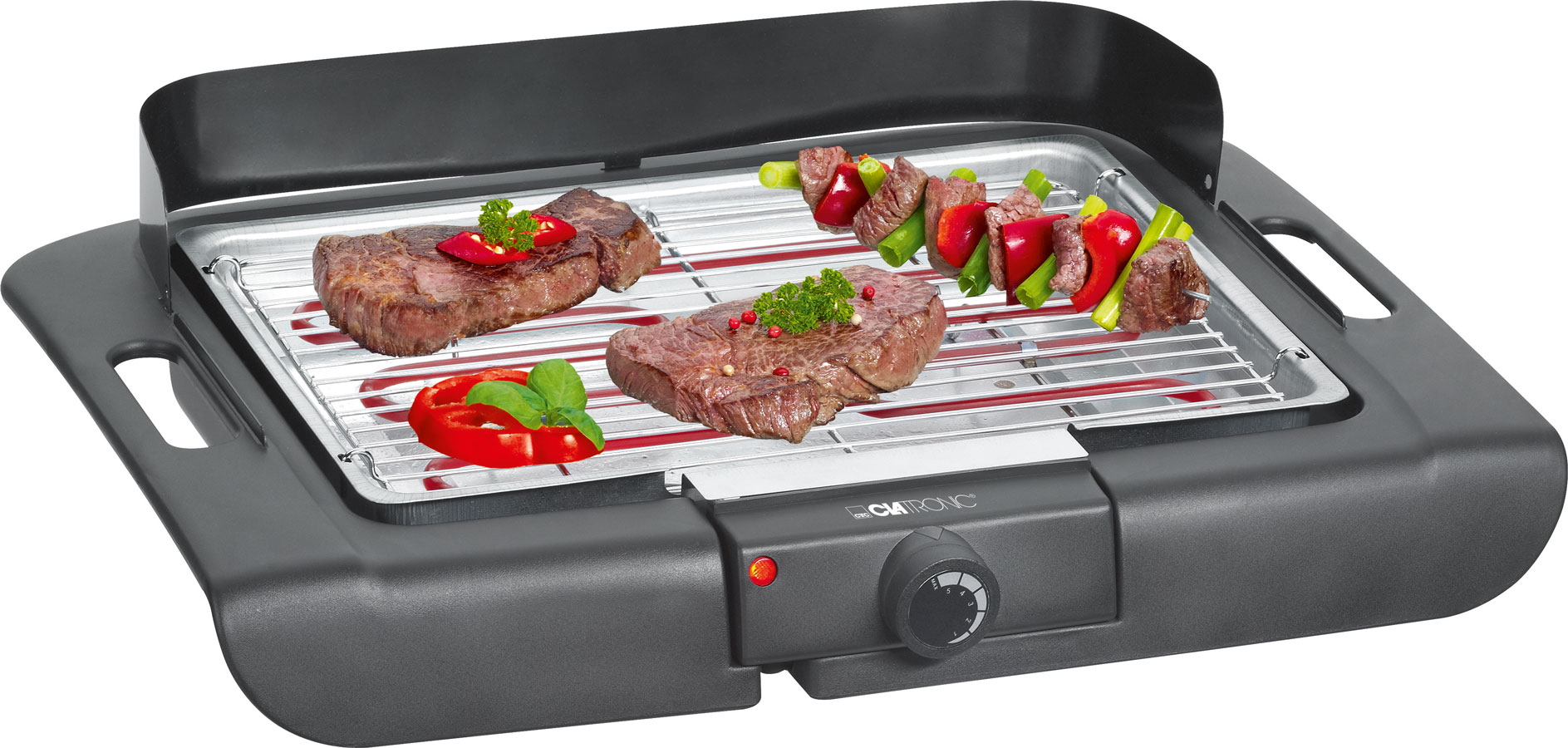 Elektrischer Tischgrill mit zwei Steaks und Gemüse. Grillfläche mit Metallrost und Temperaturregler.