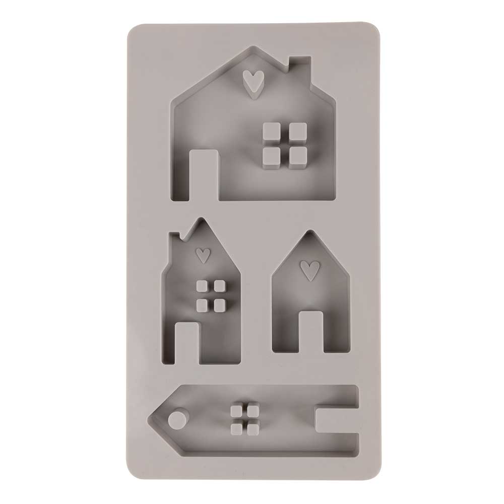 Silikonform mit verschiedenen Hausformen und einem Anhänger. Die Formen haben kleine Details wie Herzen und Fenster.