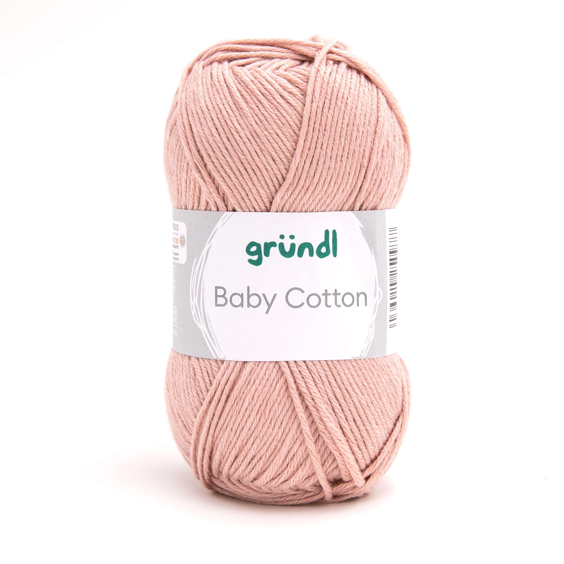 Rosa Baumwollgarn in einem runden Knäuel. Die Verpackung zeigt den Namen 'Baby Cotton' und das Markenlogo.
