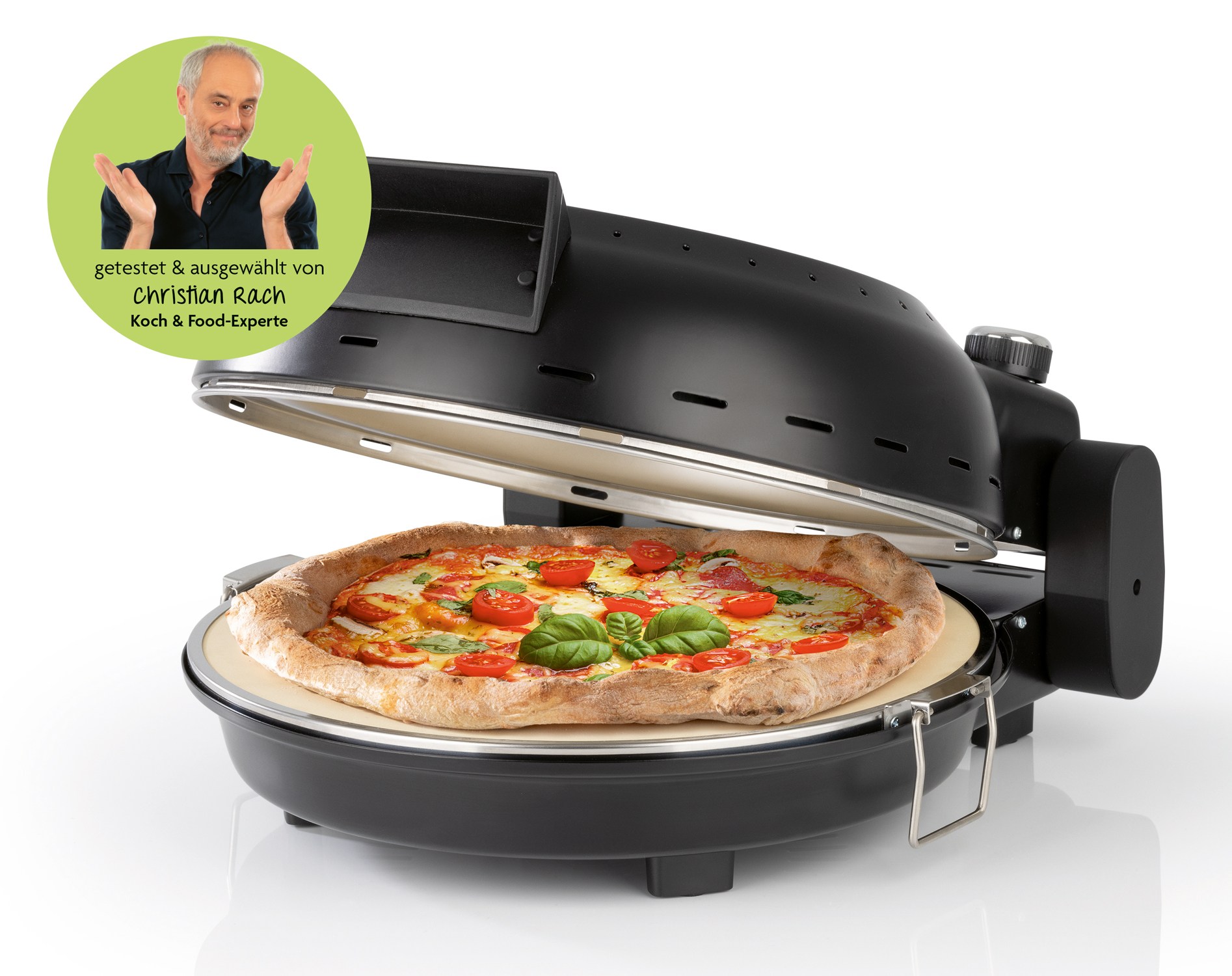 Pizzagerät mit geöffnetem Deckel. Darin eine Pizza mit Tomaten und Basilikum.