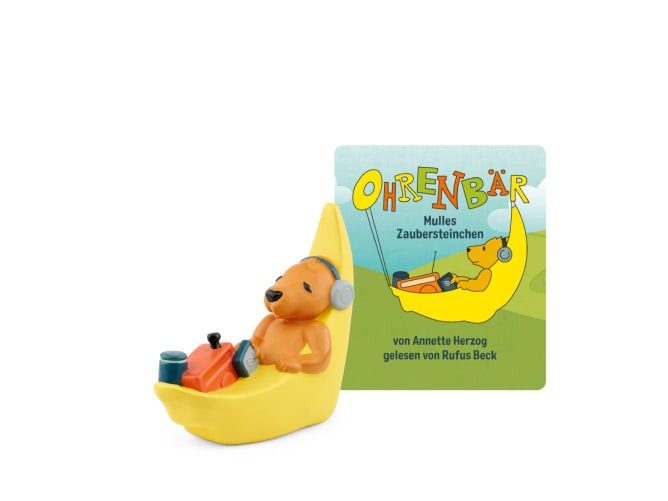 Figur eines Bären in einer gelben Banane. Dazu ein Buchcover mit dem Titel 'Ohrenbär - Mulles Zaubersteinchen'.
