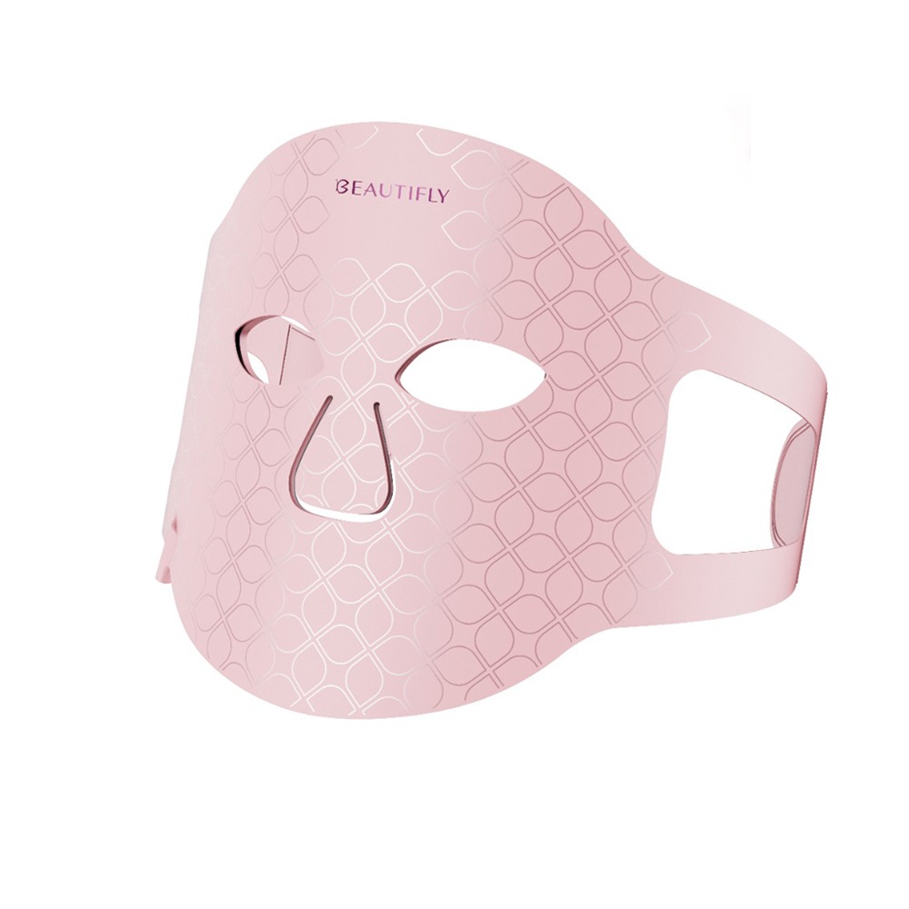 rosa Gesichtsmaske mit Augen- und Nasenausschnitten. Muster aus sich überlappenden Rauten. Elastische Bänder an den Seiten.