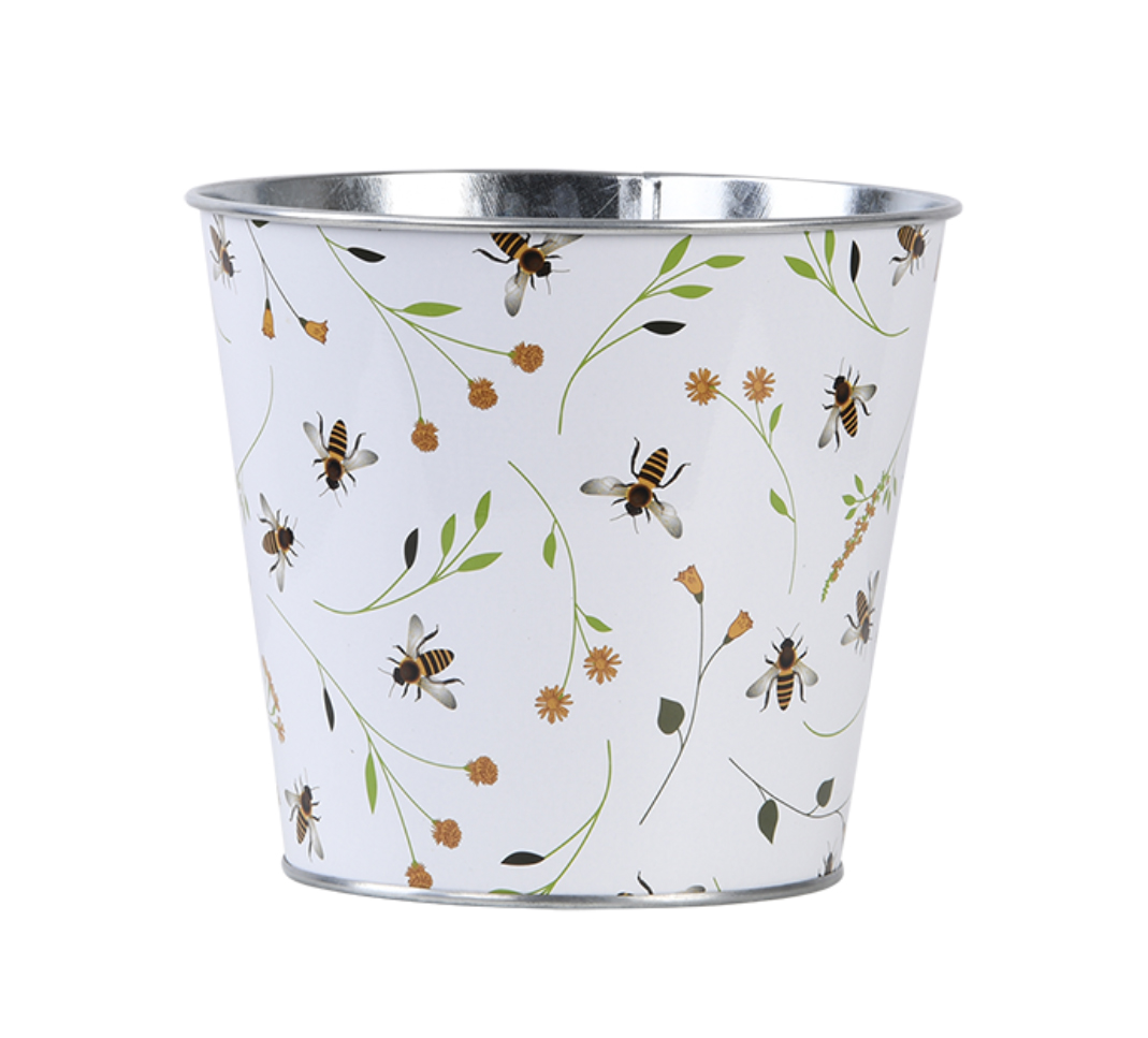 Metallischer Blumentopf mit buntem Blumen- und Bienenmuster. Weißer Hintergrund.