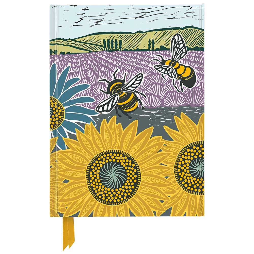 Notizbuch mit buntem Cover. Abgebildet sind Bienen, Sonnenblumen und eine Landschaft.